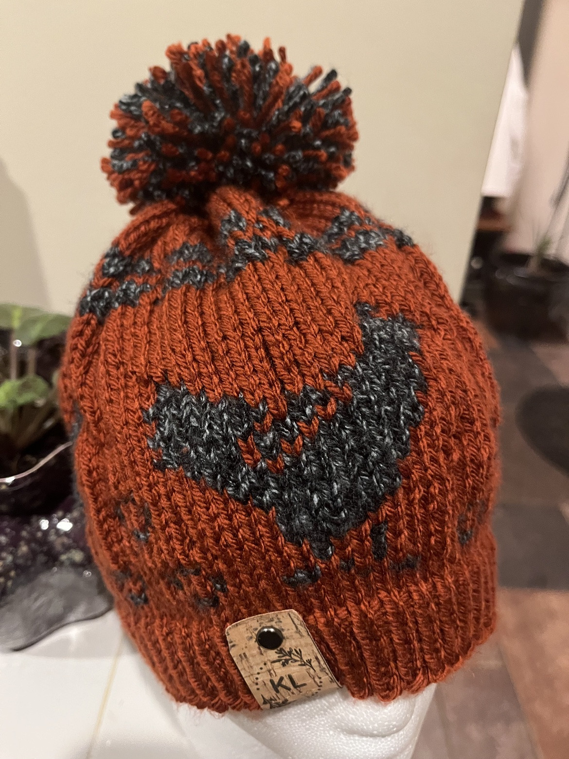 Rust and gray patterned pom-pom hat