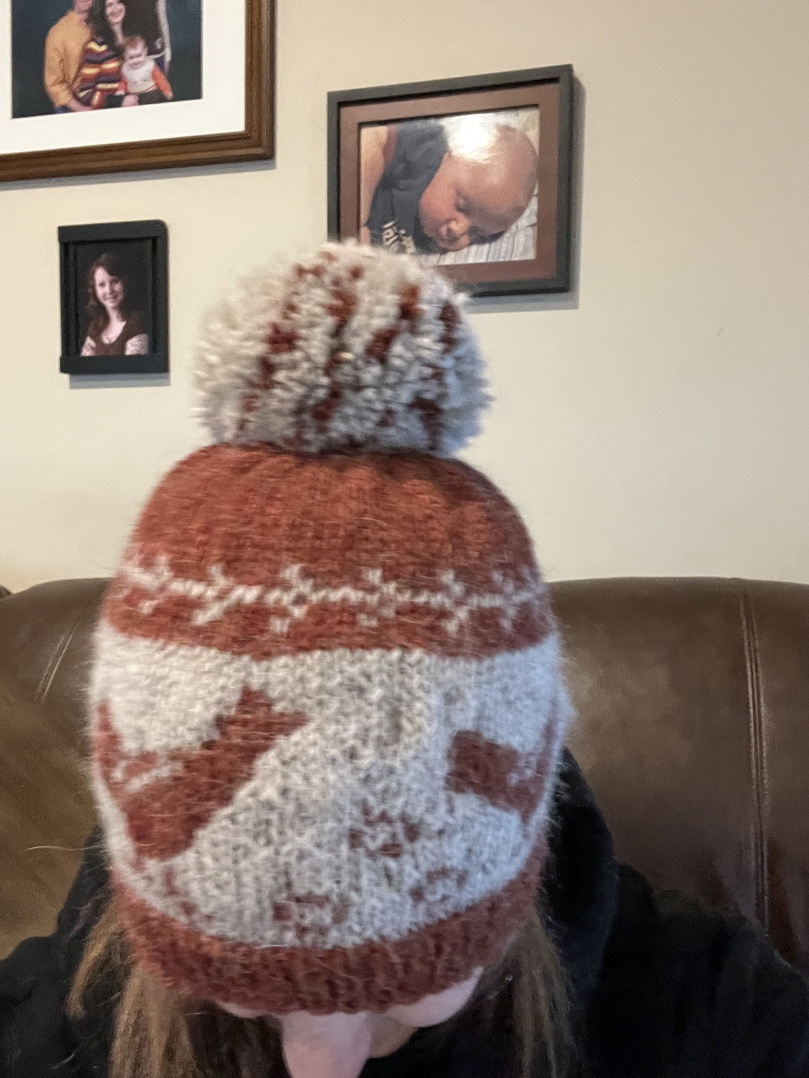 Rust, cream, and pale blue patterned pom-pom hat