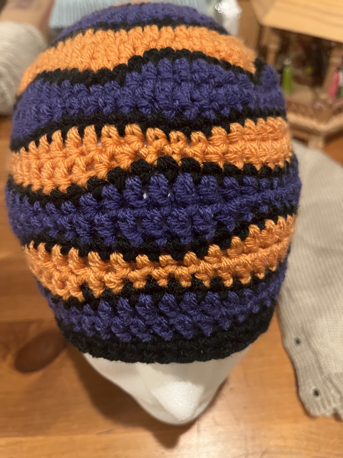 Purple, orange, and black striped crocheted hat