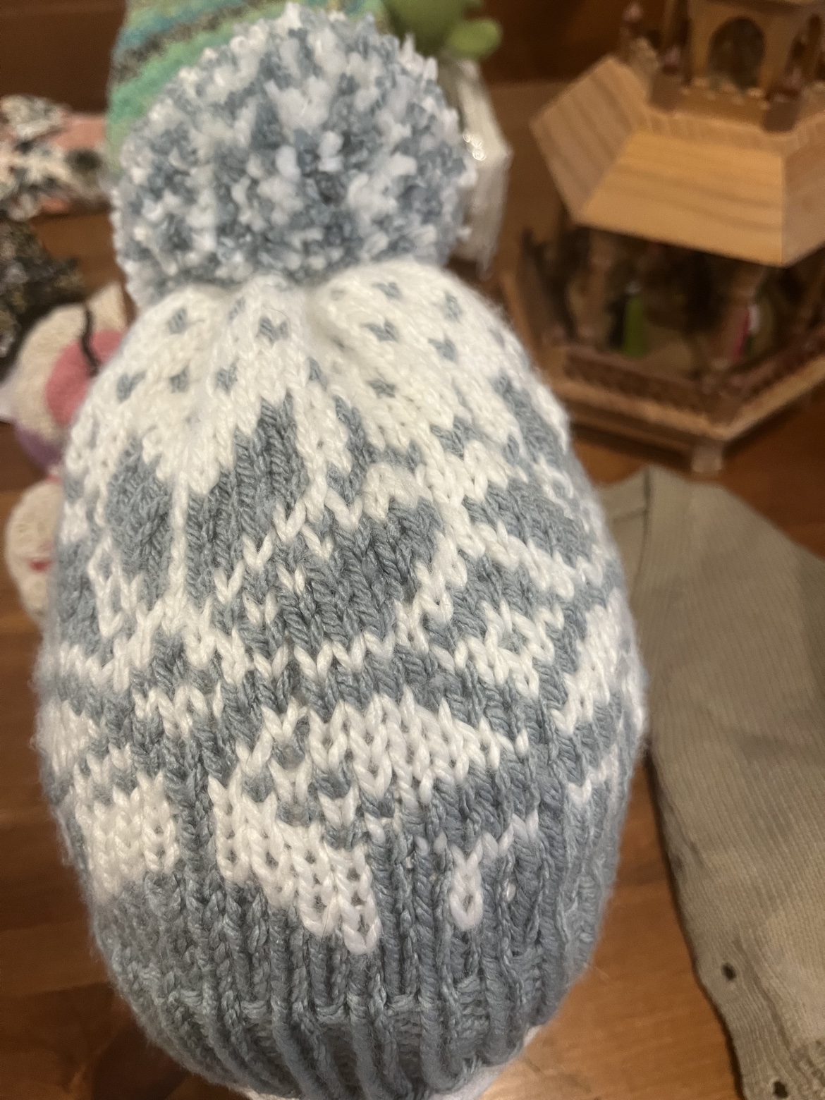 Pale blue and white snowflake knit hat with a pom-pom