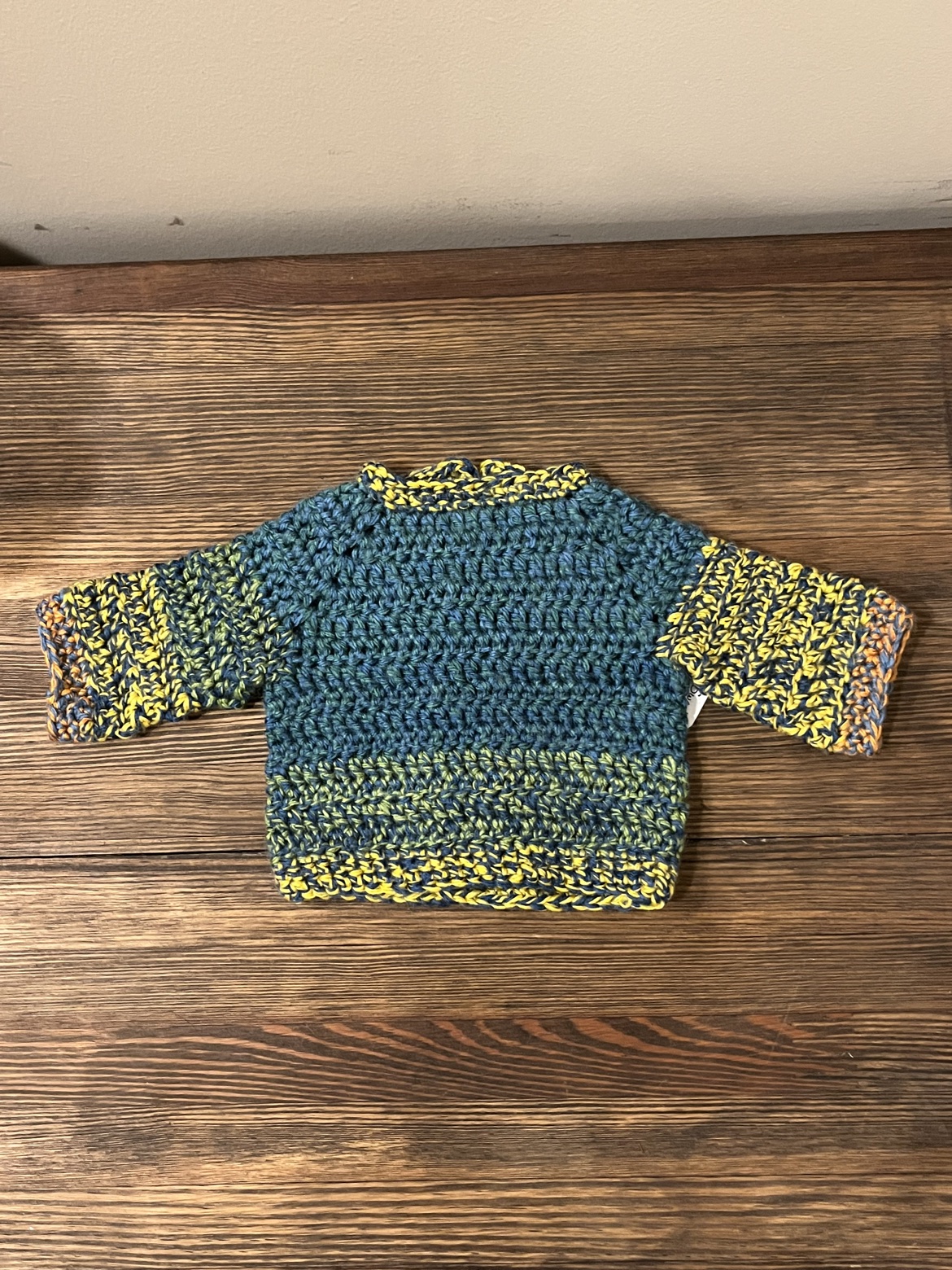 Front view of the multicolor crochet baby sweater