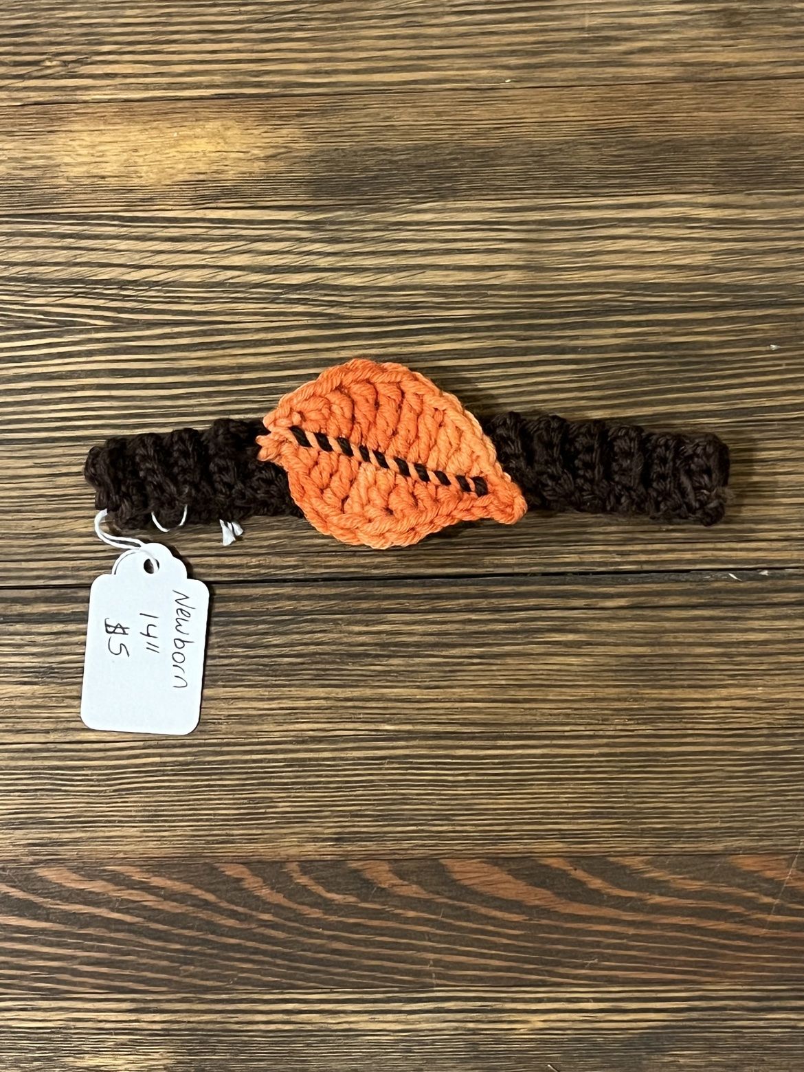 Brown crochet fall headband with an orange leaf applique