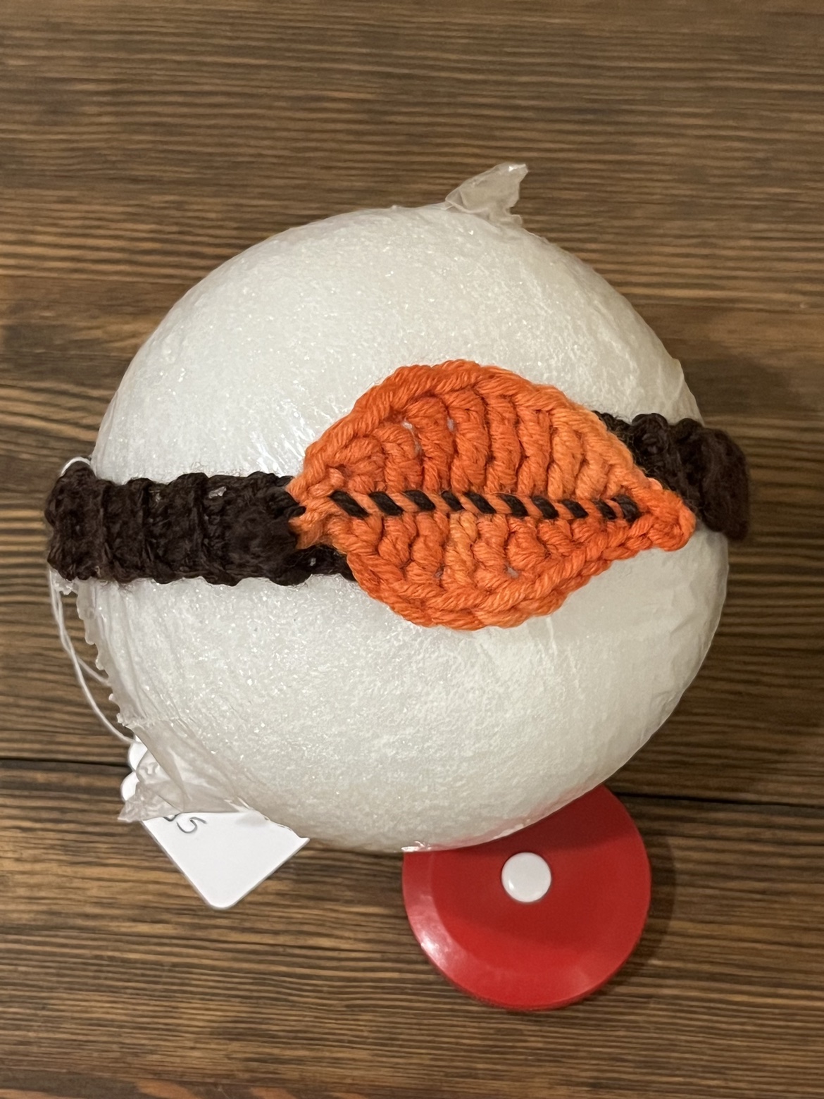Fall headband displayed on a form to show the orange leaf applique