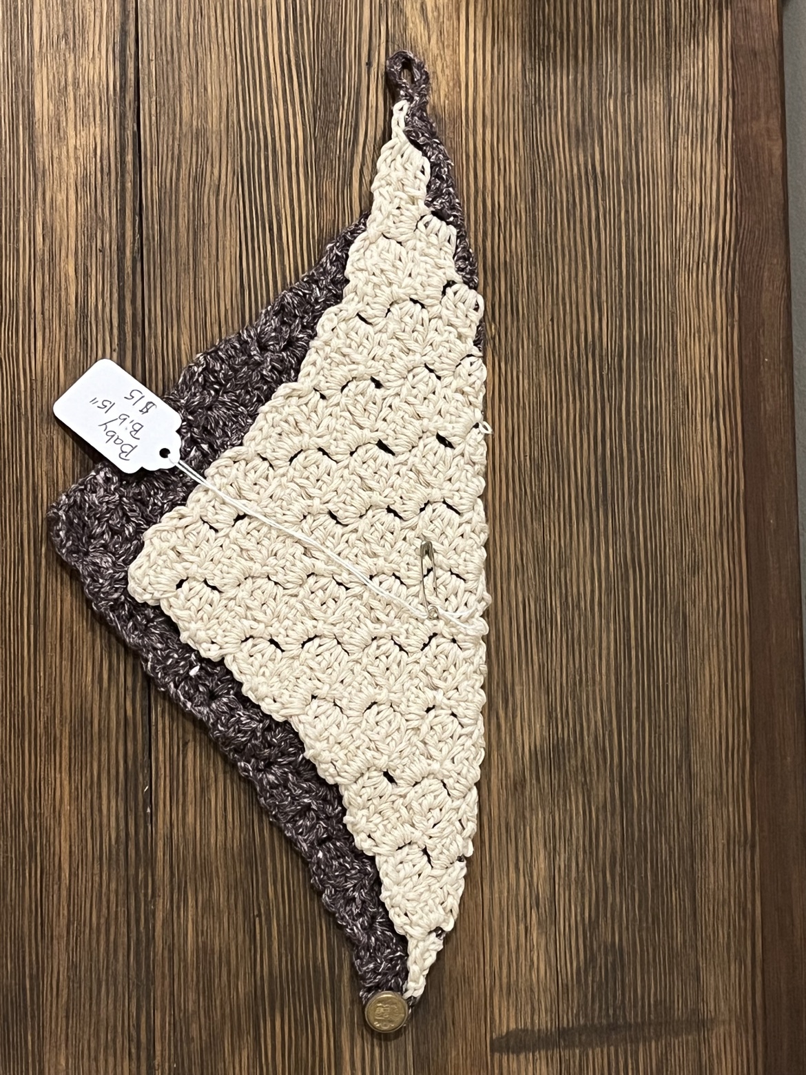 Crochet baby bib scarf laid flat to show its triangular shape