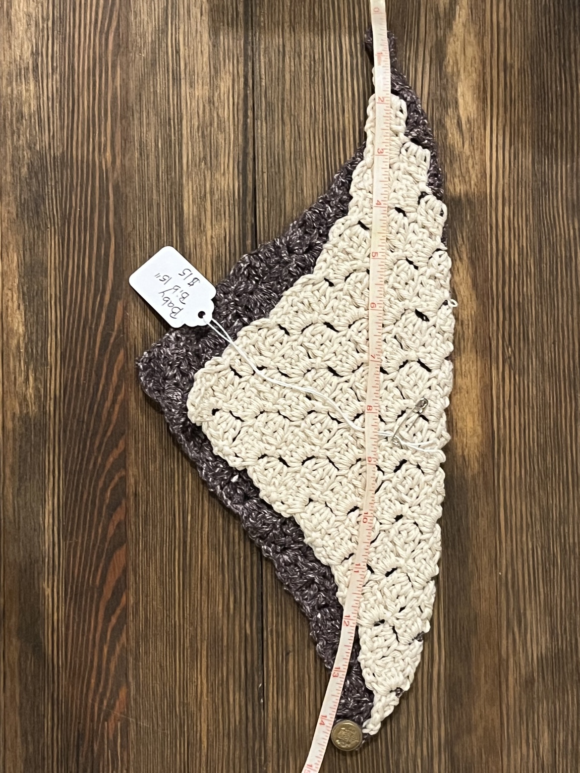 Crochet baby bib scarf shown with a measuring tape