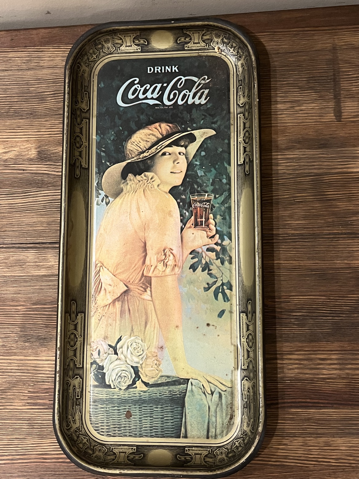 Front of the 1970s Coca Cola advertising tray with a woman holding a bottle