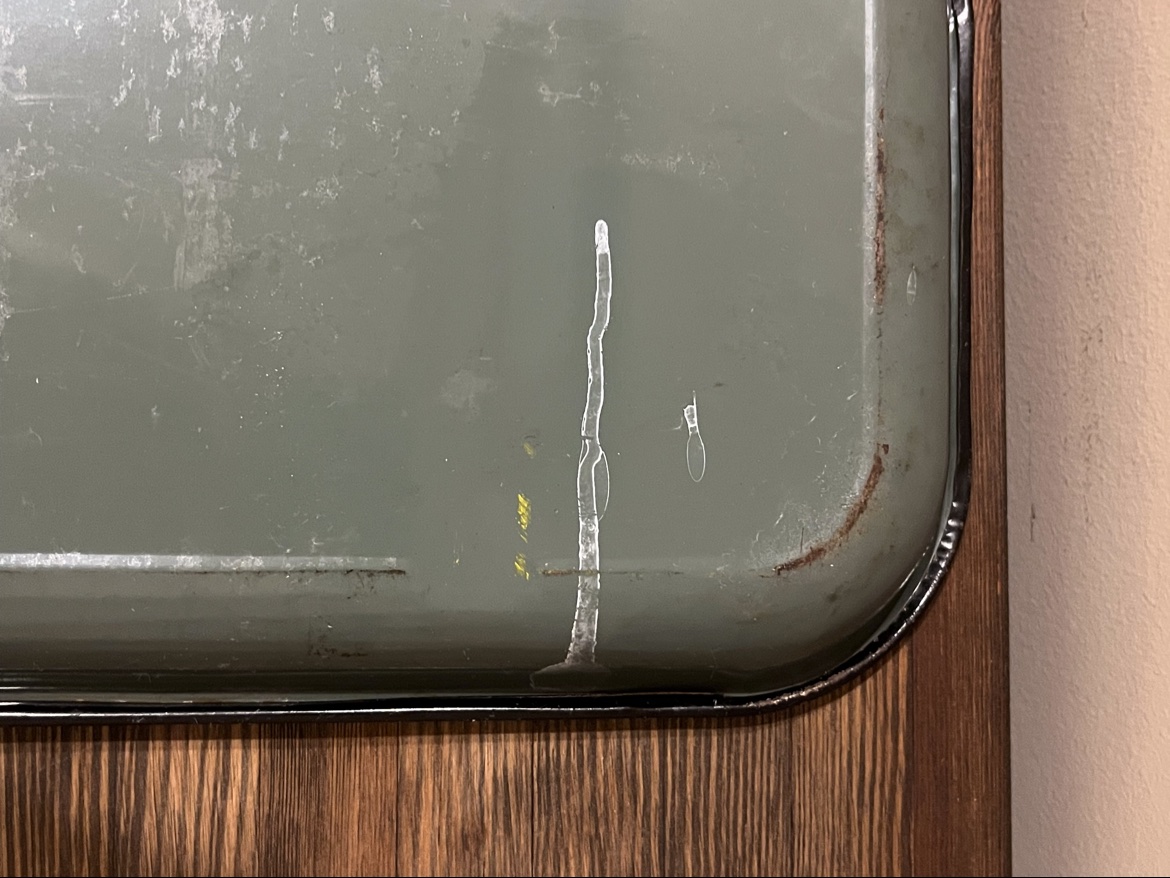 Close-up of light wear along the back edge of the Coca Cola tray