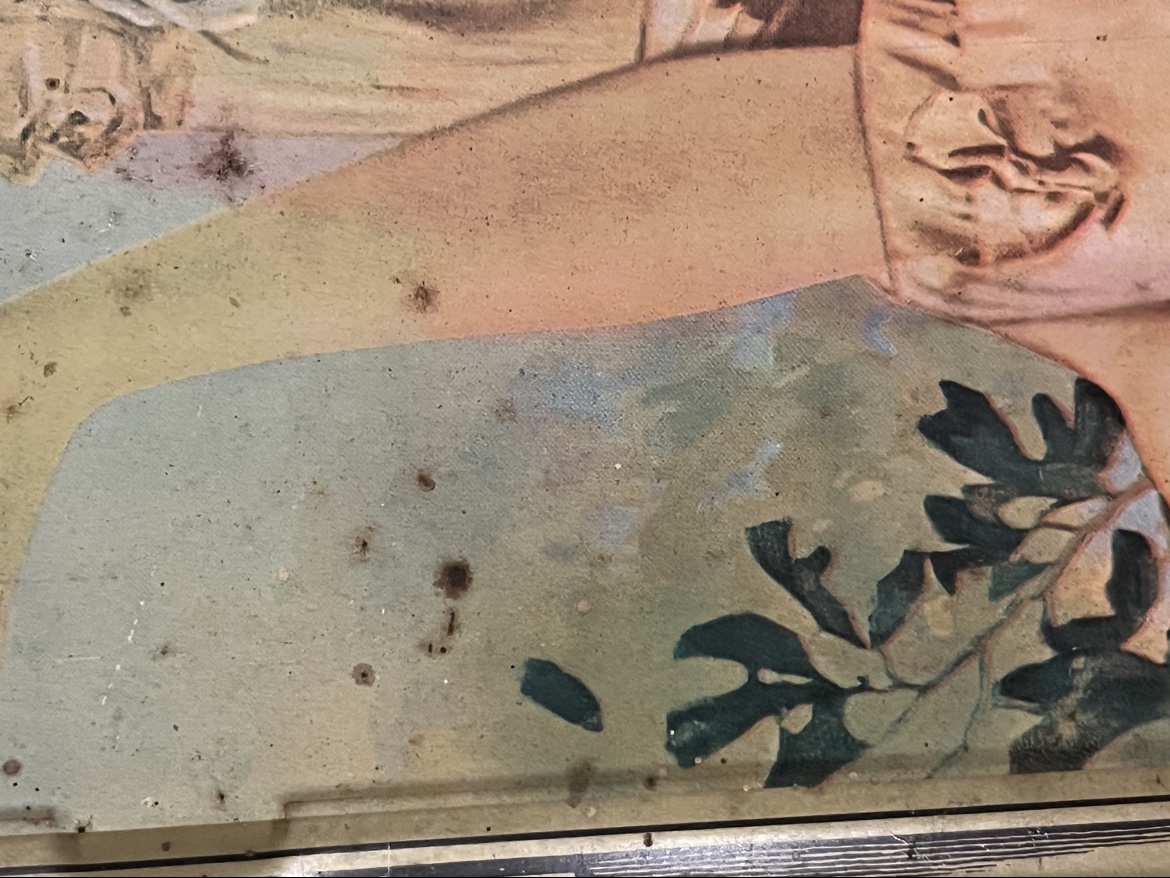 Close-up of surface wear near the bottom of the Coca Cola advertising tray