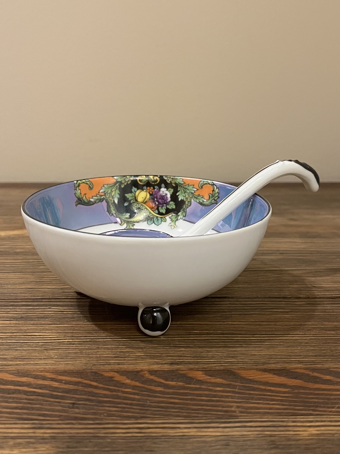 Side view of the footed Noritake lusterware mayonnaise bowl with its ladle