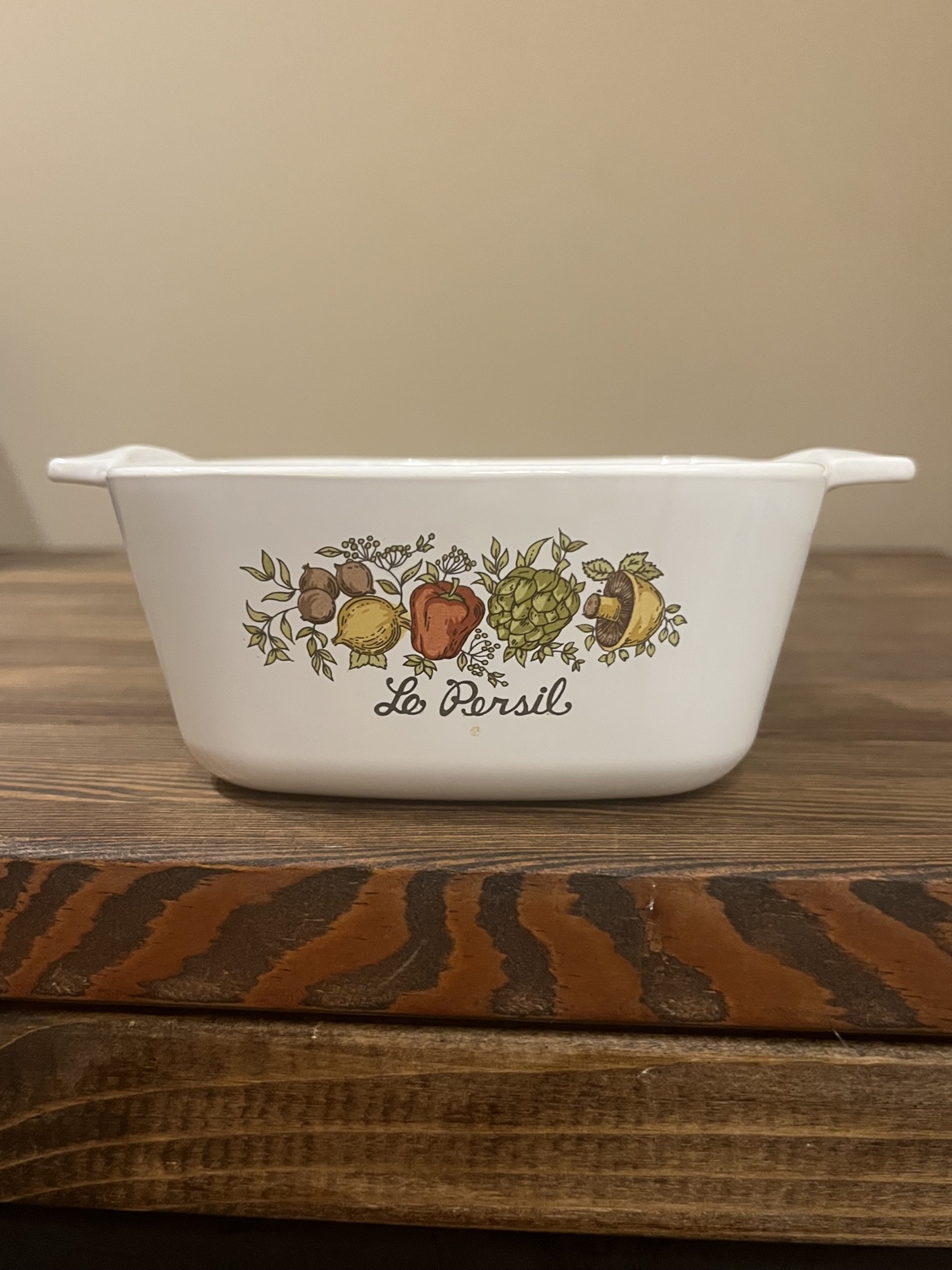 Vintage CorningWare casserole dish with vegetable pattern, front view