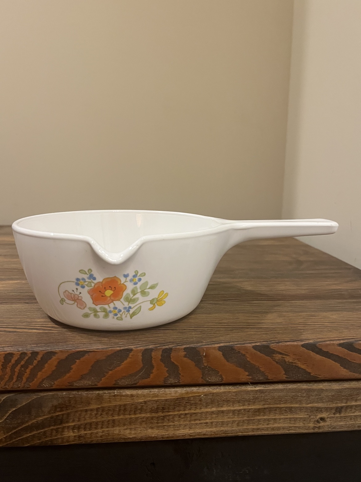 Vintage CorningWare saucepan with pour spout and floral pattern, side view