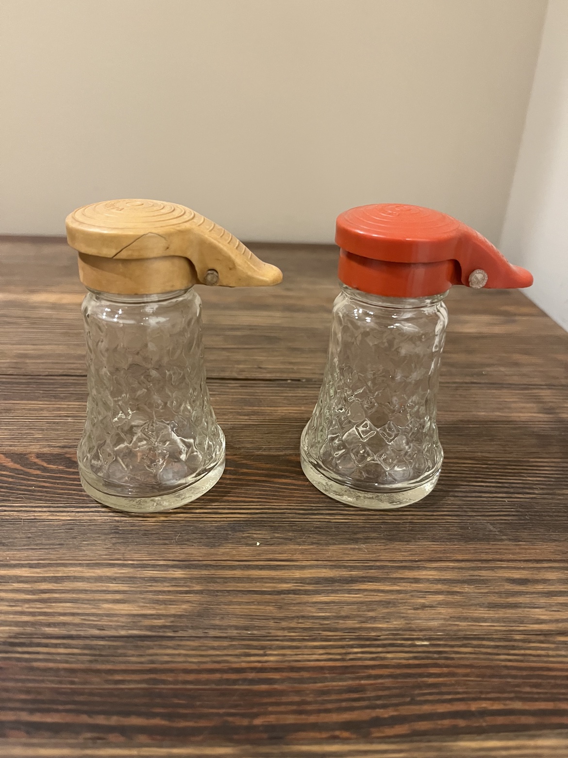 Vintage glass salt and pepper shakers with yellow and orange pour-spout lids