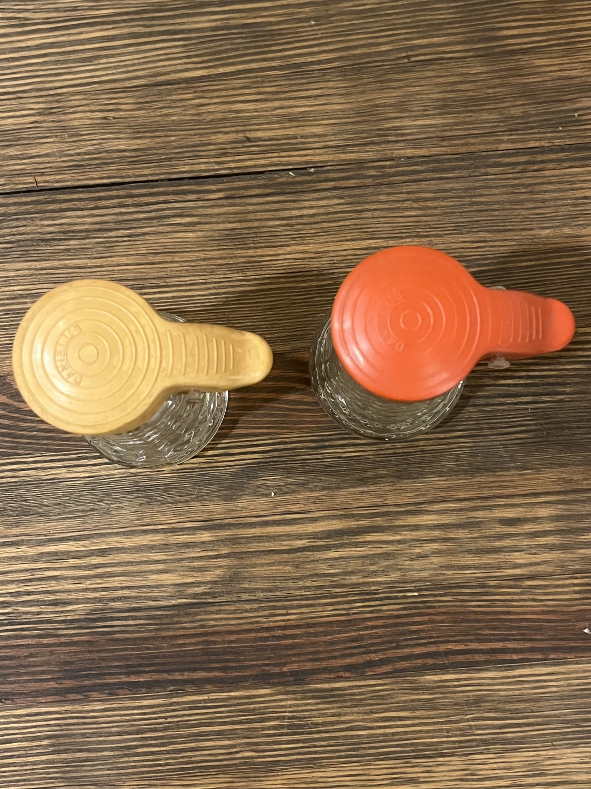 Top view of the yellow and orange lids on the vintage salt and pepper set