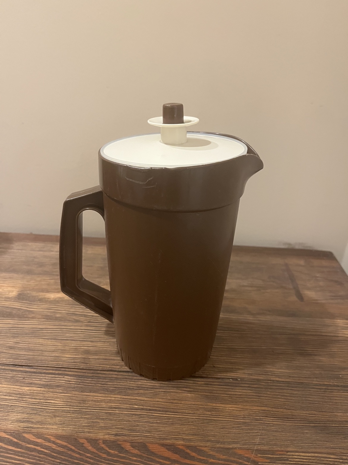 Brown vintage Tupperware pitcher with cream lid, front view