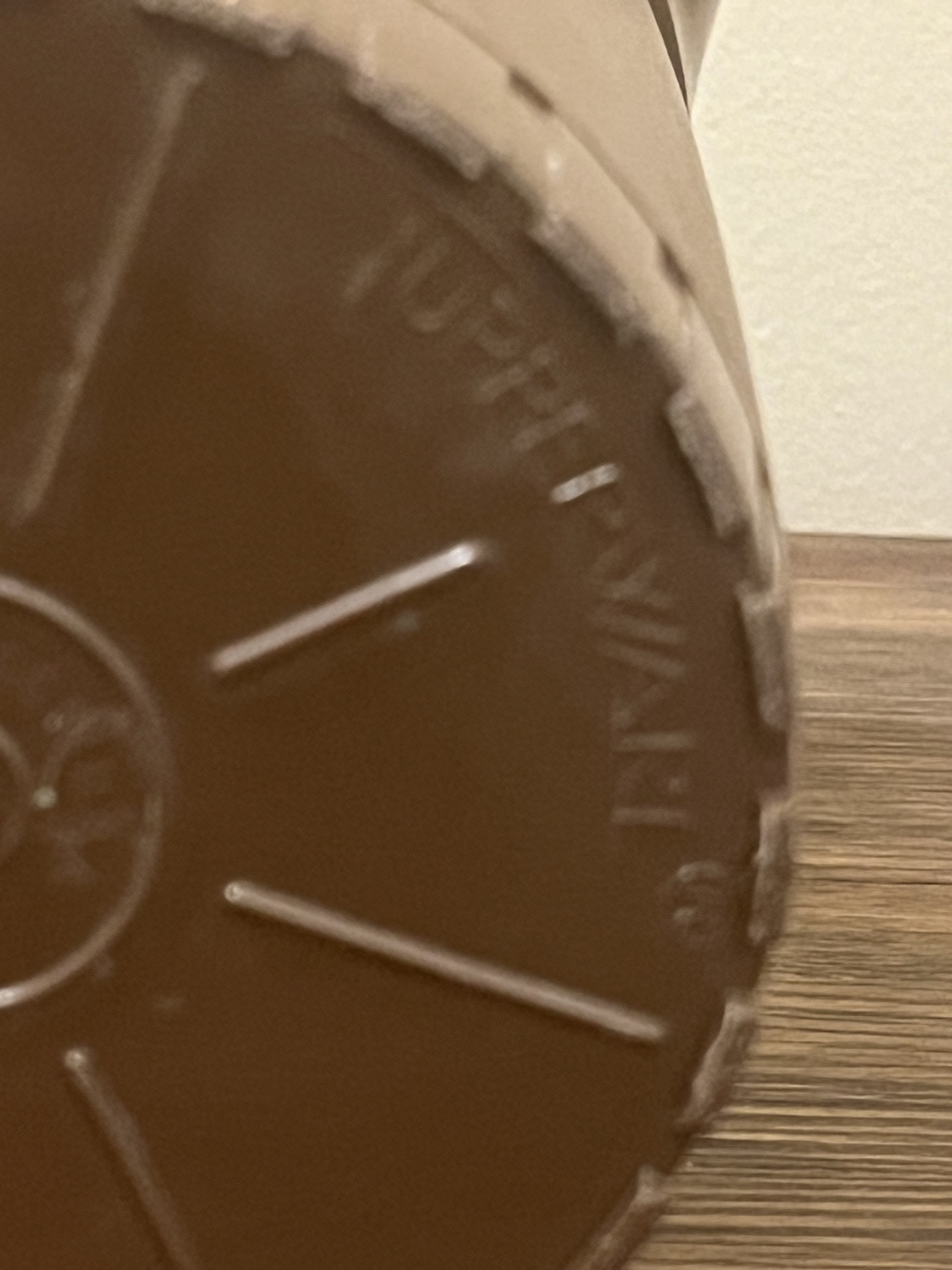 Close-up of the TUPPERWARE mark on the bottom edge